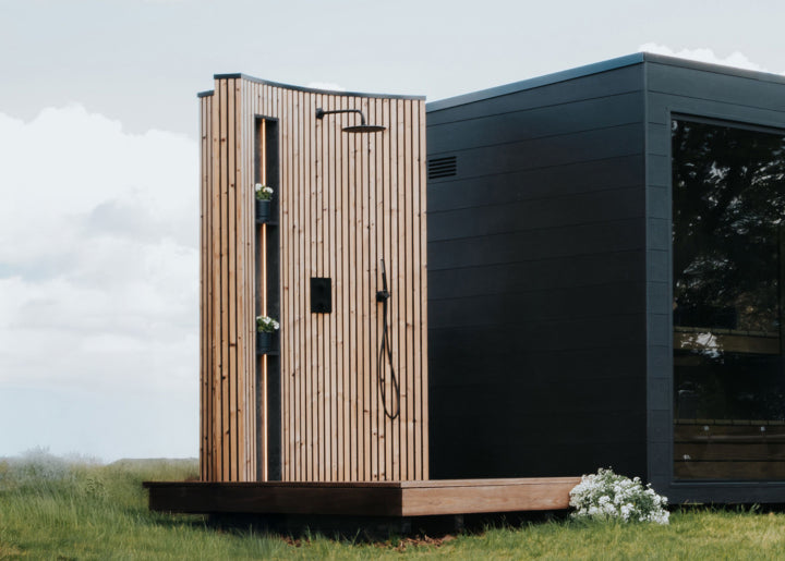 Auroom Quu sauna exterior with VelAqua outdoor shower combination wellness space