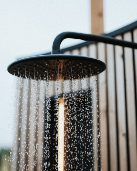 Auroom VelAqua shower head water flowing wooden fence backdrop outdoor