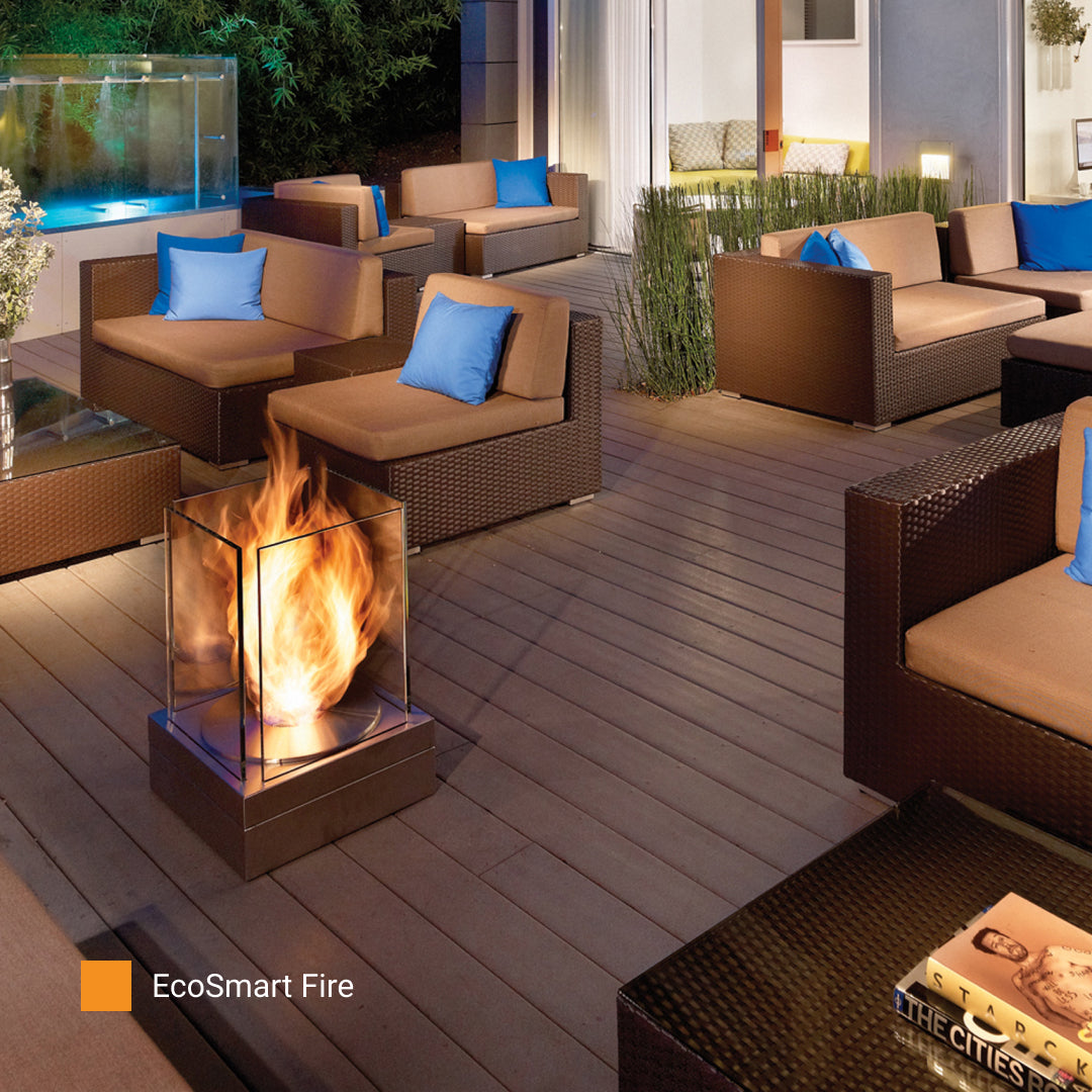 EcoSmart Fire Mini T bioethanol fireplace on an outdoor lounge deck at night