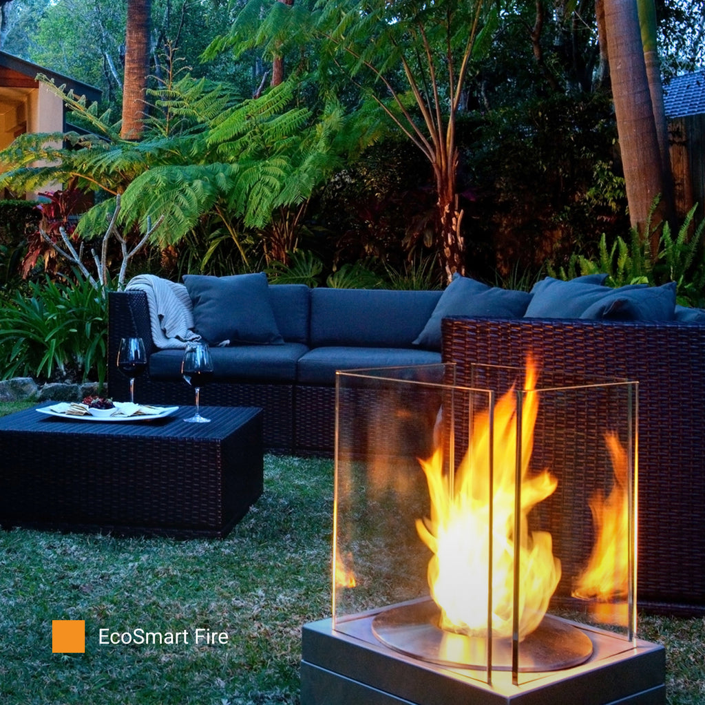 EcoSmart Fire Mini T portable fireplace in a residential courtyard by day