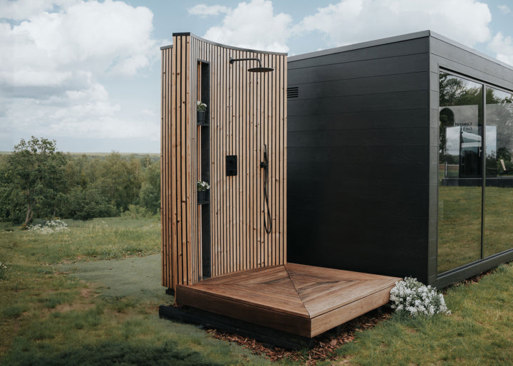 Auroom VelAqua shower full view with thermo-ash decking and green garden surround